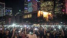 Студенти са вдигнали включени телефони по време на митинг в Хонконг. Протестите, избухнали в началото на юни, са насочени срещу закона за екстрадицията, прераснали в протести срещу правителството.