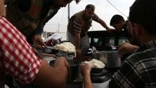 Сирийски бежанци-кюрди получават храна в бежански лагер в Иракски Кюрдистан. Хиляди бежанци пристигат от началото на операцията на Турция в Сирия.