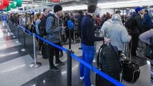 Чакащи пътници на летище &quot;О`Хеър&quot; в Чикаго, САЩ, завръщащи се по домовете си за Деня на благодарността. Тази година пътниците срещат трудности заради зимните бури и силните ветрове.