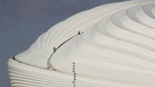 Строителни работници върху покрива на стадиона &quot;Ал Джануб&quot; в Доха, Катар, вторият от осемте, които ще приютят Световното по футбол през 2022 г.