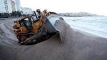 Булдозер размества купчини пясък на плажа Риасор в Ла Коруна, Галисия, Испания. Пясъкът беше раздухан от силните ветрове по време на редицата бури, които преминаха през Испания през последните седмици.